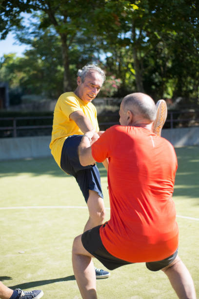 istock Determined senior men getting ready for match on sunny day 1359975442