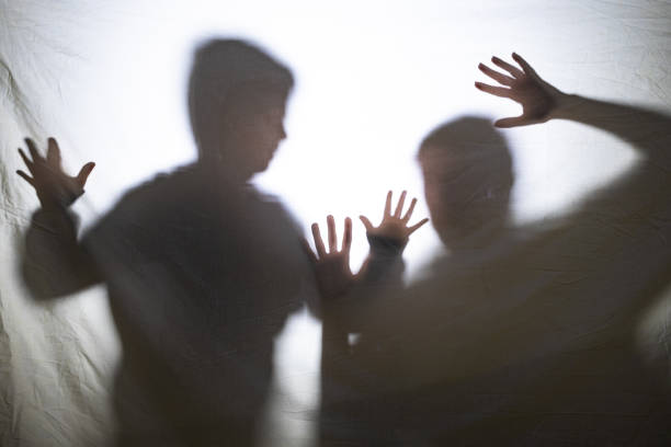 istock Mother and son playing with shadows behind a bed sheet 1359976375