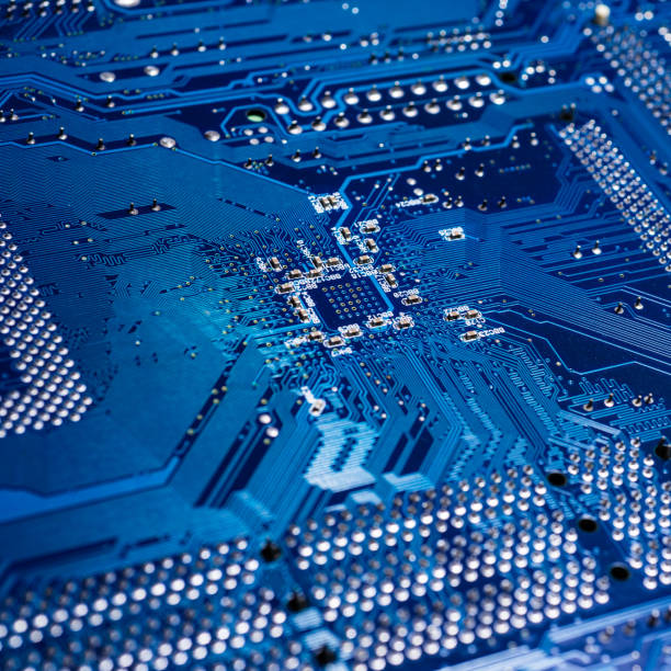 istock Motherboard with soldering points for electronic components, close-up, blue color 1359976943