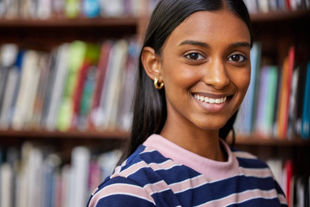 istock Shot of a female standing in a library 1359984065