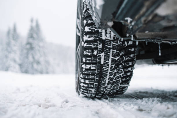 istock Snow Covered Road With Wheel Of Car 1359984599