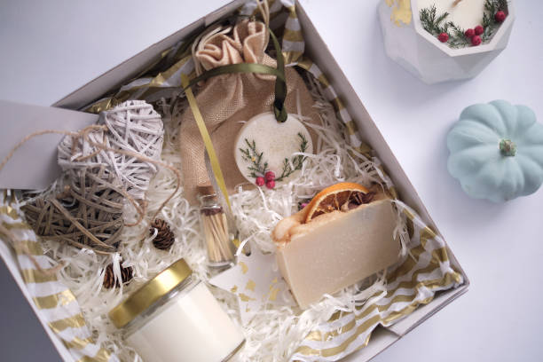 istock Preparing care package, seasonal gift box with soap and candle. Personalized eco friendly basket for family and friends for thanksgiving, christmas, mothers and fathers day holidays 1359985729