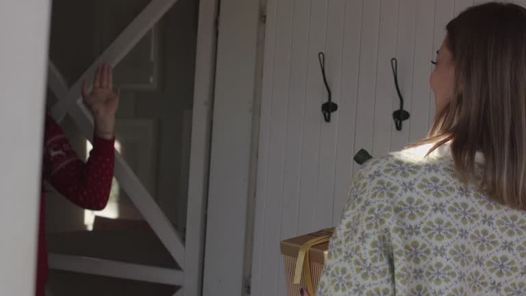 Guests arriving at their friends' house, being welcomed inside