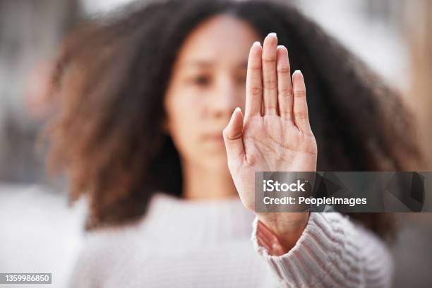Shot Of An Unrecognizable Woman Making The Stop Sign With Her Hand Outside Stock Photo - Download Image Now