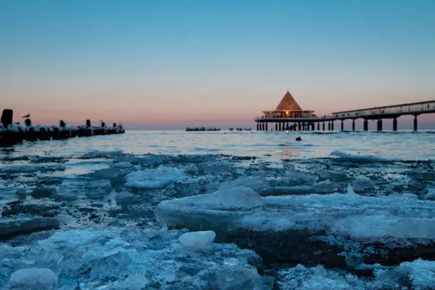 View over ice floes in the Baltic Sea to the famous pier of Heringsdorf / Germany on Usedom