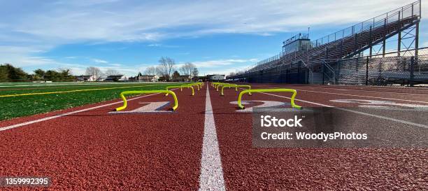 Looking Down The Track At Yellow Mini Hurdles In Two Lanes Stock Photo - Download Image Now