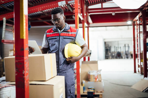 istock African American warehouse worker storing cardboard boxes 1359992419