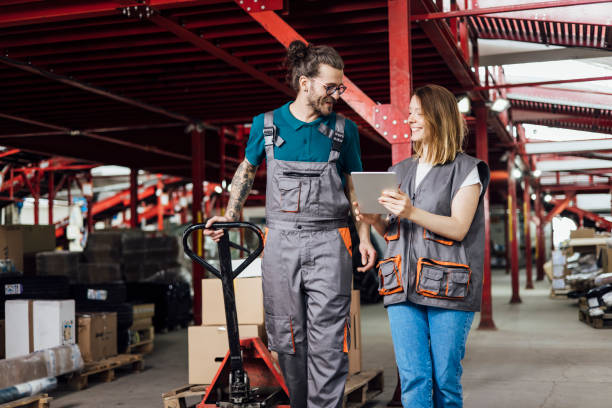 istock Young man and woman working at the warehouse on transporting boxes 1359992429