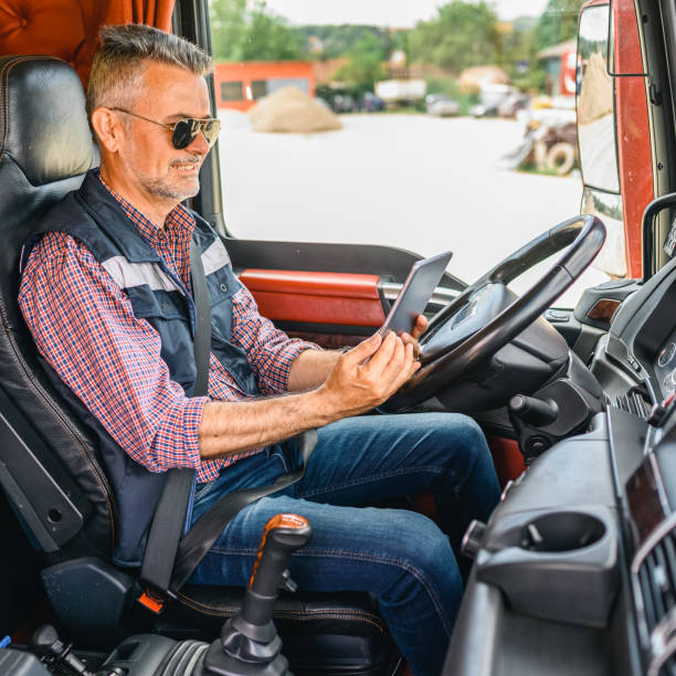 istock Mature truck driver using a mobile app 1359992461