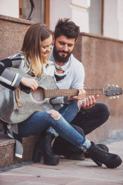 istock Couple with a guitar 1359993431