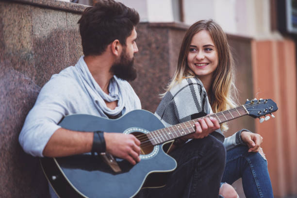 istock Couple with a guitar 1359993560