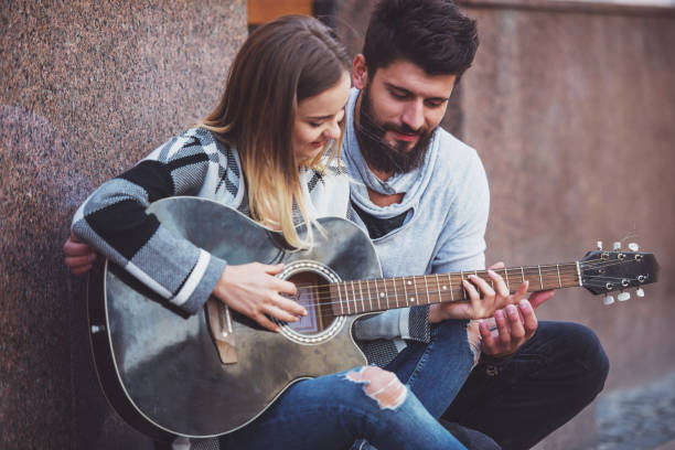 istock Couple with a guitar 1359993591