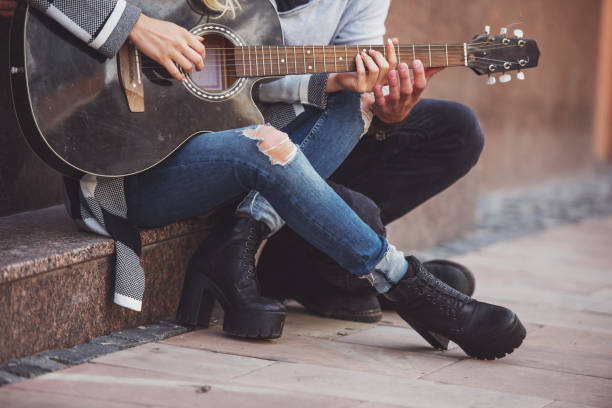 istock Couple with a guitar 1359993613