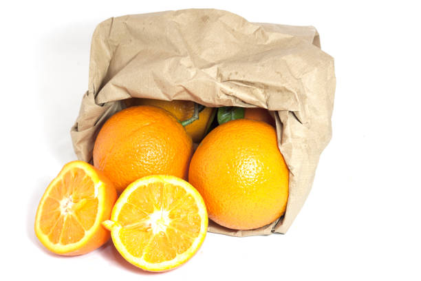 istock yellow meal oranges with recyclable paper bag 1359994576