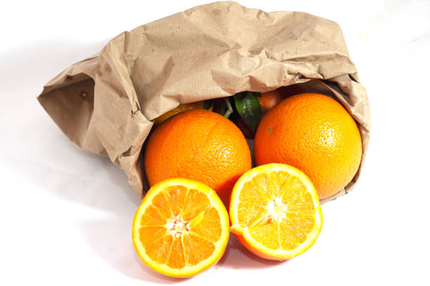 istock yellow meal oranges with recyclable paper bag 1359994622