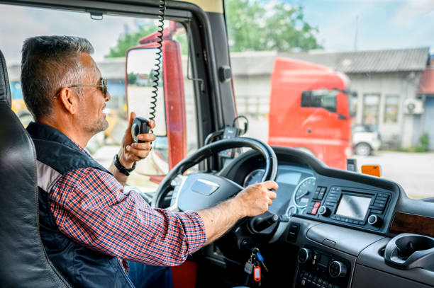 istock Mature truck driver CB talking 1359996236