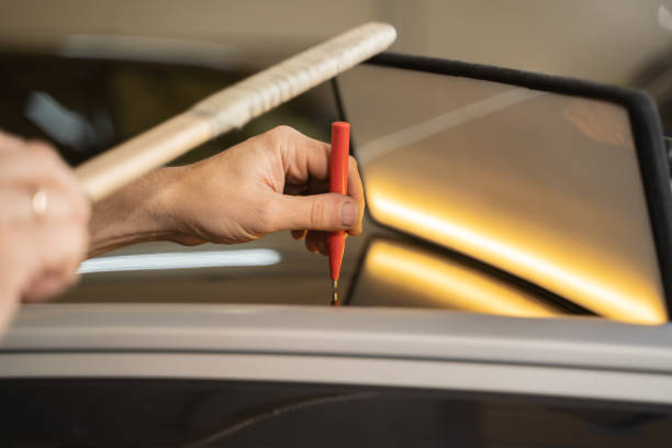 istock Process of Repairing Dents On Car Body. Technician Is Working Using Professional Tools For Paintless Dent Repair. Man Is Repairing Dents On Car Roof After Hail. PDR Removal Course 1360000038