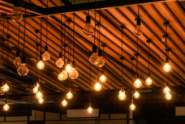 istock Lighting bulb hanging at wooden ceiling 1360000088