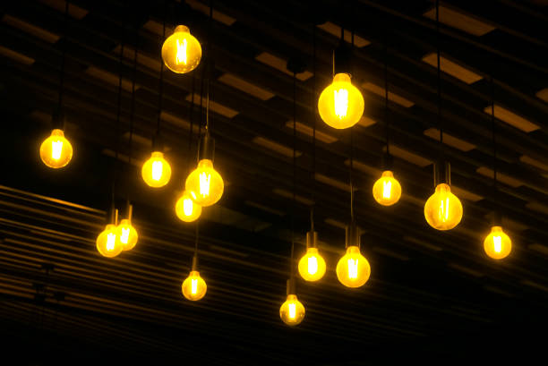 istock Lighting bulb hanging at wooden ceiling 1360001852