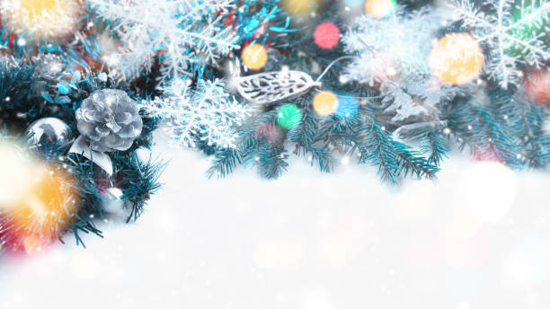 istock Silver Christmas cones on a spruce background with bokeh. Christmas background. copy space 1360003673