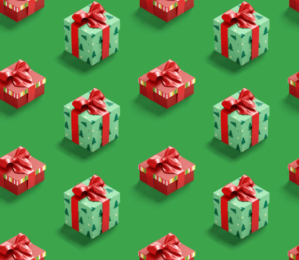 Pattern of Santa hat on paper gift box present on green background. Copy space for your text. Mock up for advertisement. Holiday Christmas texture composition. Minimalistic greeting card. Creative