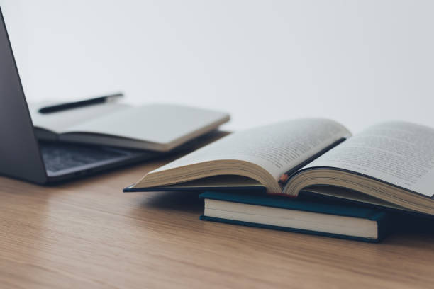 istock Computer laptop with book. Business success idea and studying concept 1360005061