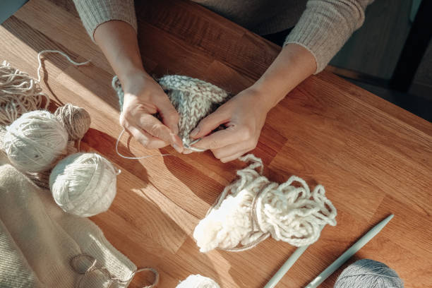 istock Knitting.Recycling, environmental friendliness, zero waste, recycling,  friendly,Knitted sweater and threads for knitting from yarn, Cozy knitting, small business 1360006107
