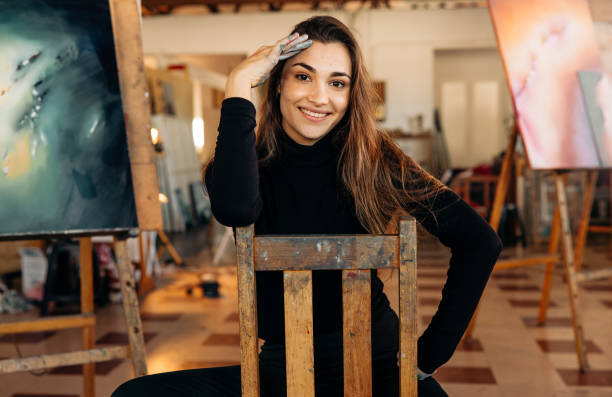 istock Successful female painter smiling at the camera 1360006429