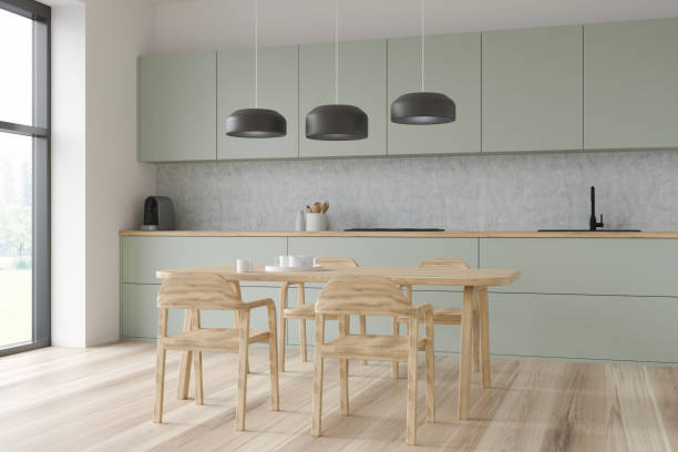 istock Light green and wood kitchen with pendant lamps 1360007434