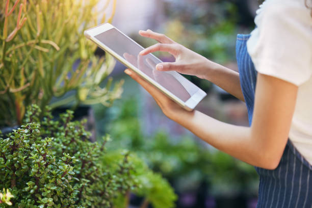 istock Shot of a nursery owner using her digital tablet 1360007856