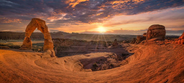 istock delicate arch in arches national park with sunset 1360007934