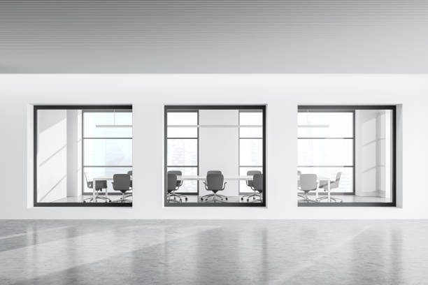 istock View of white office corridor with three meeting room windows 1360008675