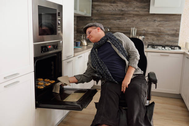 istock Contemporary man with disability baking cookies 1360009075