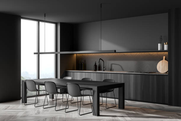 istock Corner view of minimalist dark grey kitchen with accent illumination 1360010572