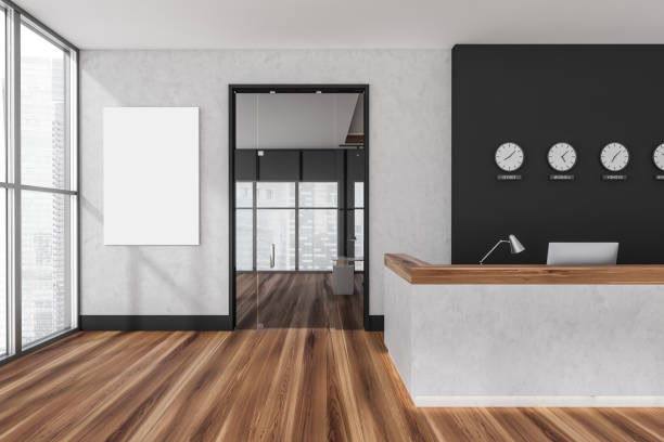 istock Poster on wall in white and black reception area with wood floor 1360010603