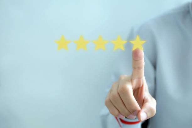 istock Customer review good rating concept hand pressing five star on visual screen and positive customer feedback testimonial, copy space for text. 1360012087