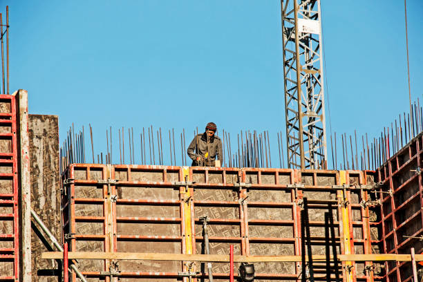 Dnepropetrovsk, Ukraine - 10.30.2021: Construction of a high-rise building. Workers prepare formwork for pouring concrete.