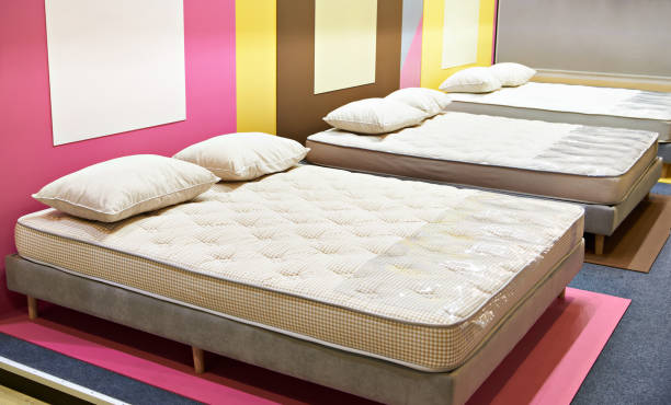 istock Modern bed with mattresses and pillows in store 1360013348
