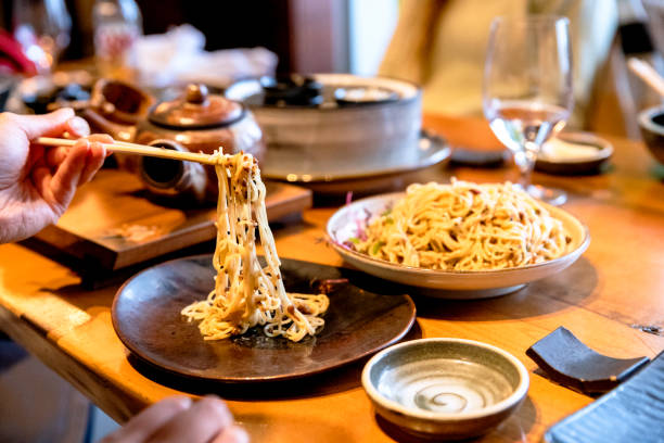istock Eating Tan Tan noodles with chopsticks 1360013735