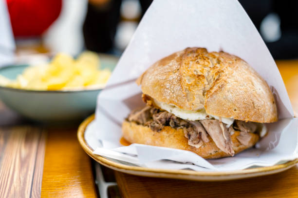 istock Delicious bun with delicate piglet and egg with chips aside 1360014856