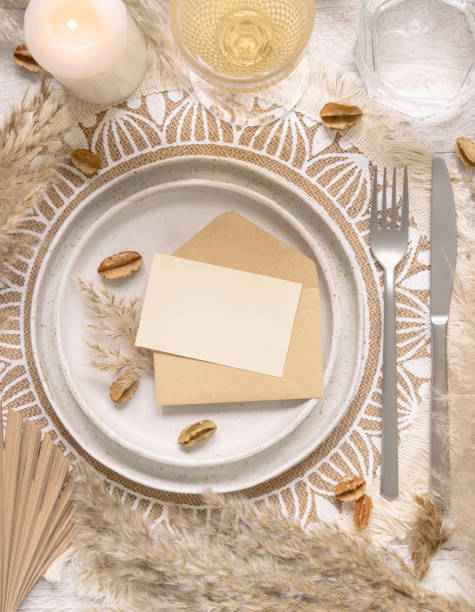 istock Boho Wedding Table place with Blank card over envelope near pampas grass 1360014906