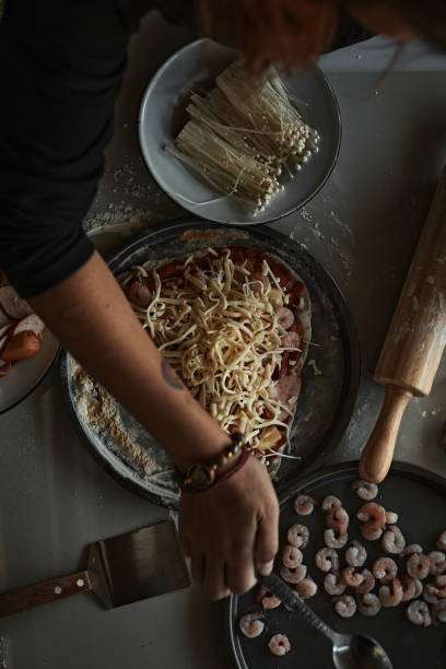 istock A closeup of hand making an Italian pizza 1360015405