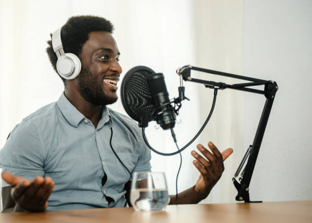 istock Black man recording podcast and gesticulating 1360016634