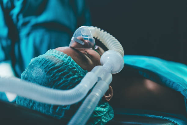 istock Patient wearing ventilator lying on bed the operating bed during surgery process. saving life emergency. medical healthcare concept. 1360019723