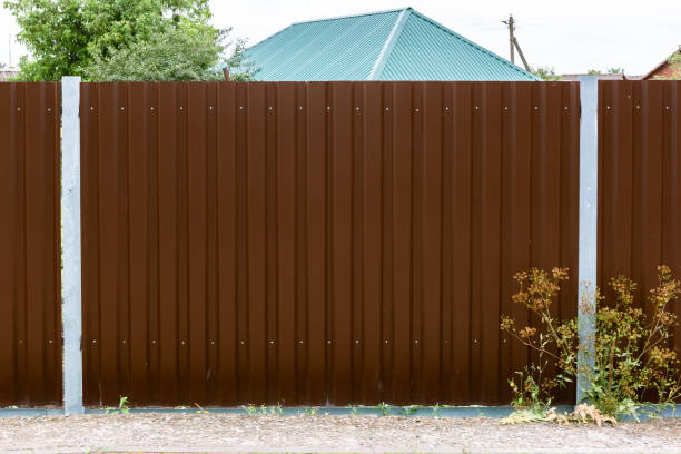 istock Close-up of a brown metal profile fence. Corrugated surface. Copy space. Security. Private property fencing. Opaque hedge. Outdoor house exterior. Steel material. High. Side view. Urban or indastrial 1360022882