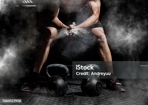 istock Weightlifter clapping hands and preparing for workout at a gym 1360022908