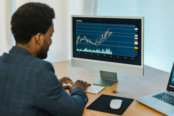 istock Black male trader typing on keyboard 1360023368