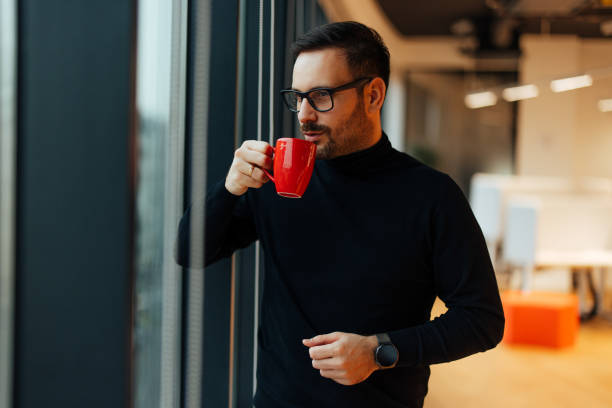 istock Calm caucasian man, taking a sip of his coffee, during a work break. 1360023929