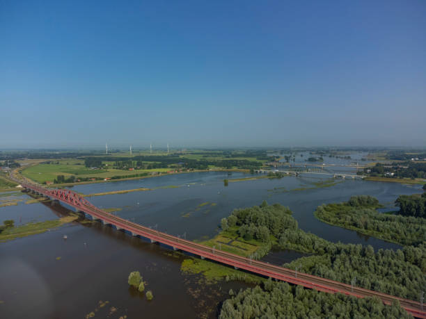 istock Hanzeboog train bridge with high water level on the floodplains 1360025137