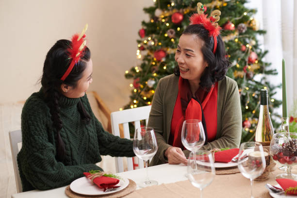 istock Mother and Daughter Celebrating Christmas 1360025435